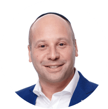 Portrait of a bald man wearing a kippah and a blue blazer, smiling, representing Nussbaum family lawyers in Toronto